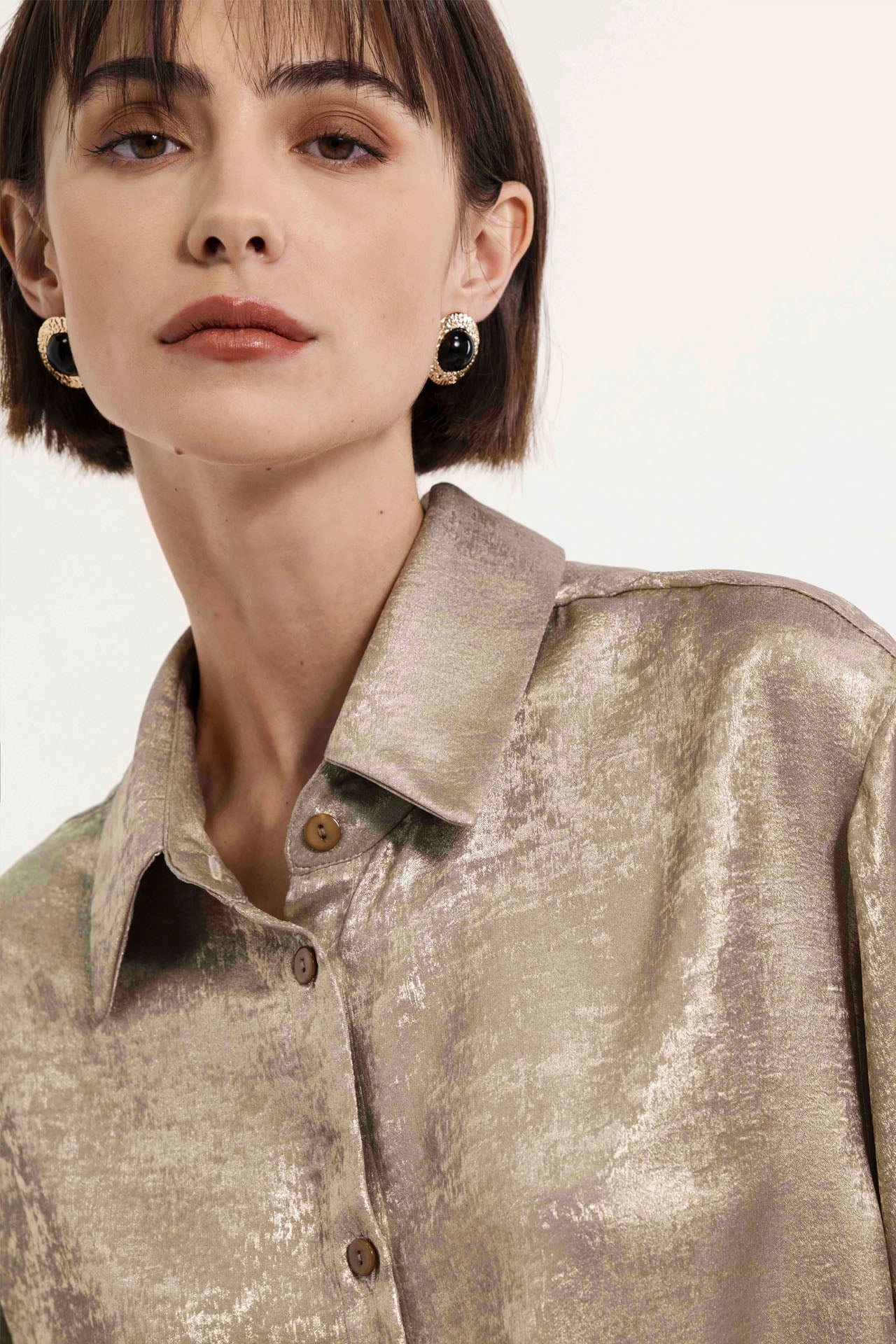 Shiny gold shirt with wide sleeves