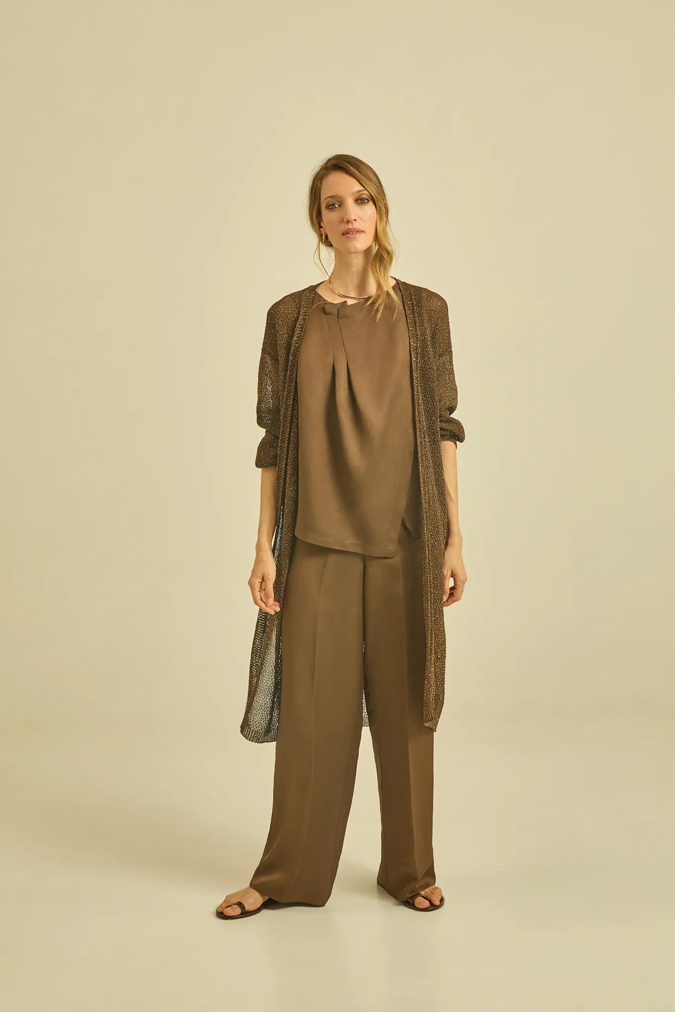 Sleeveless top with asymmetrical pleats